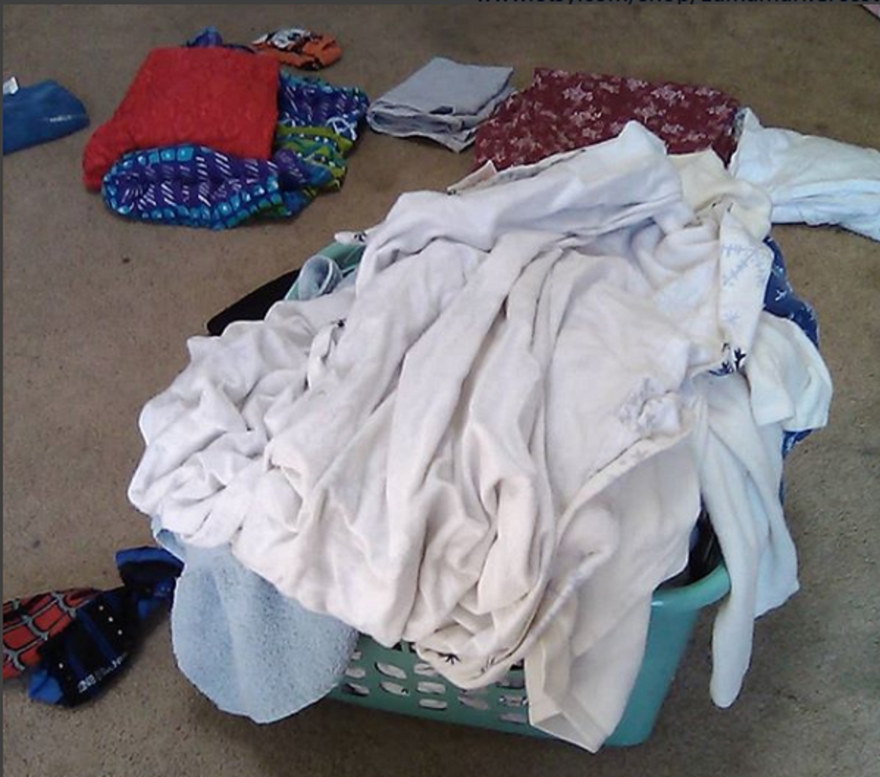 Photo I took with my phone of the laundry basket and some folded laundry Photo I took with my phone of the laundry basket and some folded laundry