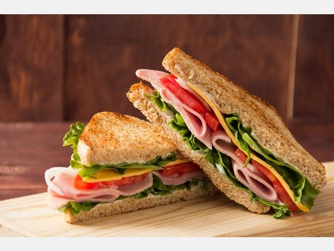 A kind female customer buys a police officer a sandwich quietly A kind female customer buys a police officer a sandwich quietly