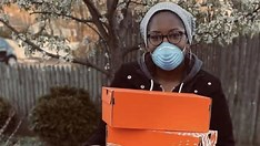 Ajon Crump with a package of sneakers that will be shipped to a nurse