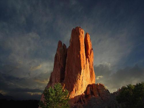 Tower of Babel at the Garden of the Gods  - Tower of Babel at the Garden of the Gods  Description: Constructed of red sandstone, the jagged rock tower stretches into the ominous sky; but hope, in the form of golden light, is near.