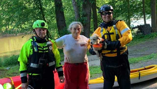 Two firefighters with Sharon Steinmiller who was rescued on Saturday 