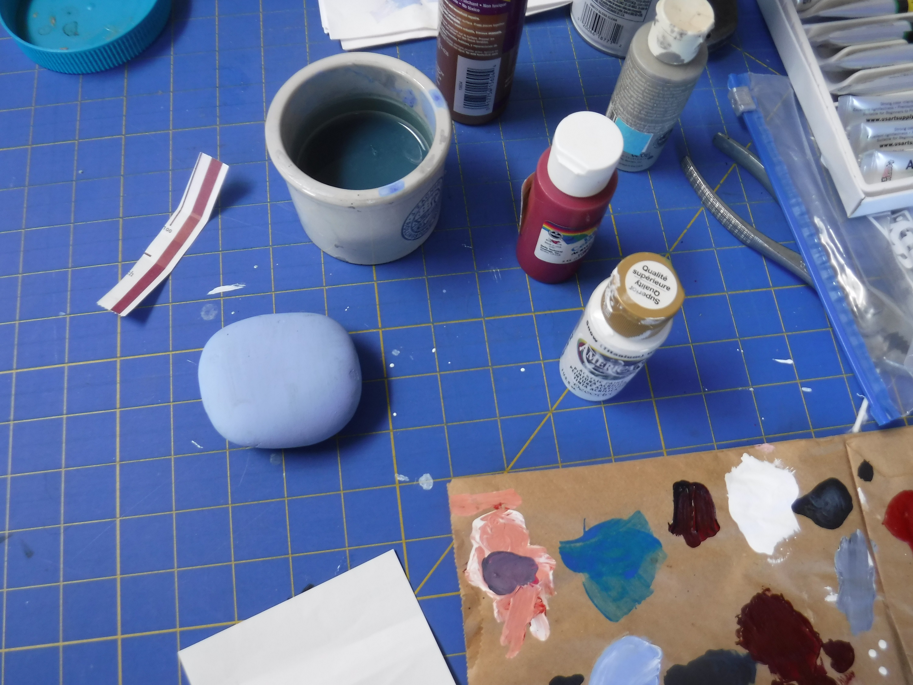 Photo taken by me of a blank rock amongst my paint and things Photo taken by me of a blank rock amongst my paint and things