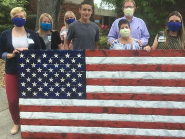 Lorenzo Liberi and family with an American flag that he craved at home. Lorenzo Liberi and family with an American flag that he craved at home.