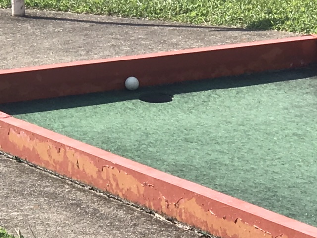 The ball stopped — ON A SLOPE — just above the hole.  It’s a game of inches!  Photo taken by and the property of FourWalls.