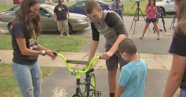 Harvey Illinois high school students donate a bicycle to a child