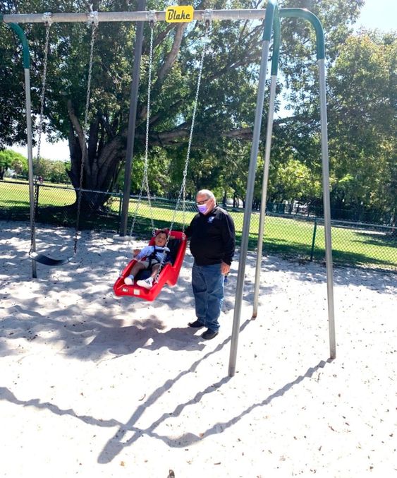Blake Pena riding on a swing at a park in Key Largo Florida Blake Pena riding on a swing at a park in Key Largo Florida