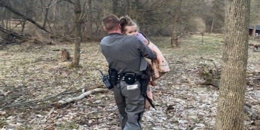 Officer Hotchkiss carrying a two year old missing girl down a mountain Officer Hotchkiss carrying a two year old missing girl down a mountain