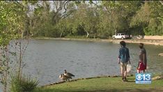 Two California children doing their part to clean up garbage in a lake Two California children doing their part to clean up garbage in a lake