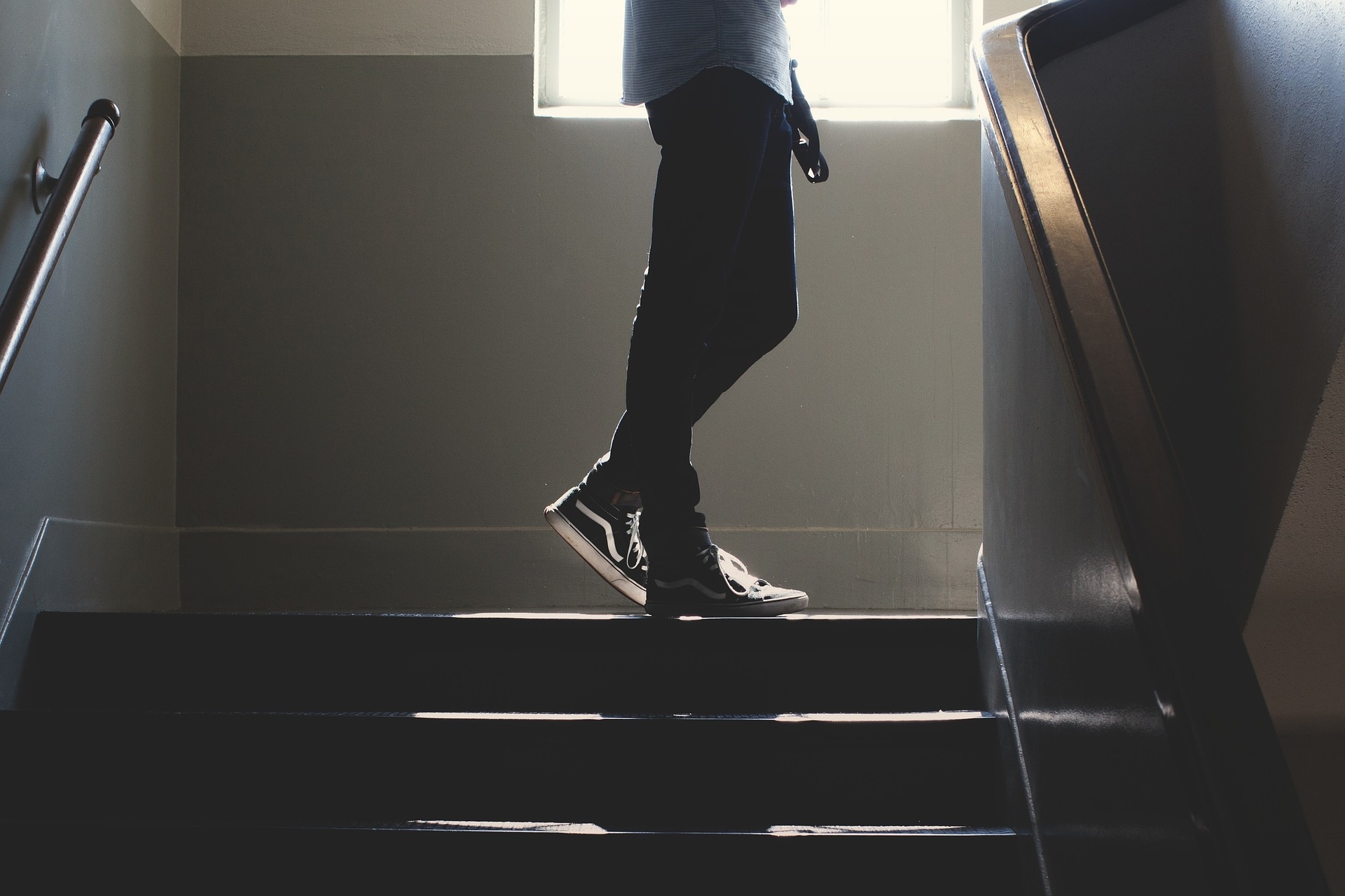 John in the stairwell, delivering mail to the different floors, of his building.