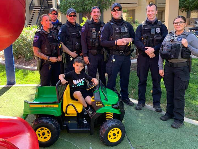 Tempe Police officers donate a lost tractor toy to a child