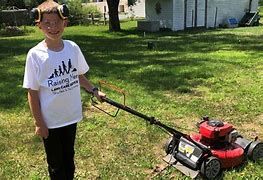 JR Atcheroff and his lawn mower in Michigan at work JR Atcheroff and his lawn mower in Michigan at work