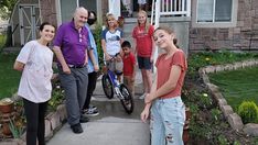 Salt Lake County volunteers with a repaired bicycle Salt Lake County volunteers with a repaired bicycle