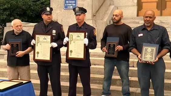 Three bystanders and two Yonkers police officers receiving an award on Wednesday