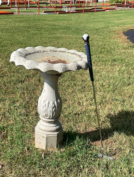 A friend's putter leaning against the birdbath at the Columbus, Indiana Putt Putt. Photo taken by and the property of FourWalls. A friend's putter leaning against the birdbath at the Columbus, Indiana Putt Putt. Photo taken by and the property of FourWalls.