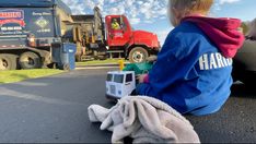 Emma White with her toy truck that was given to her by the local garbage collector Emma White with her toy truck that was given to her by the local garbage collector