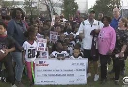 A youth football team receives a gift from the New York Giants and Dunkin' Donuts A youth football team receives a gift from the New York Giants and Dunkin' Donuts