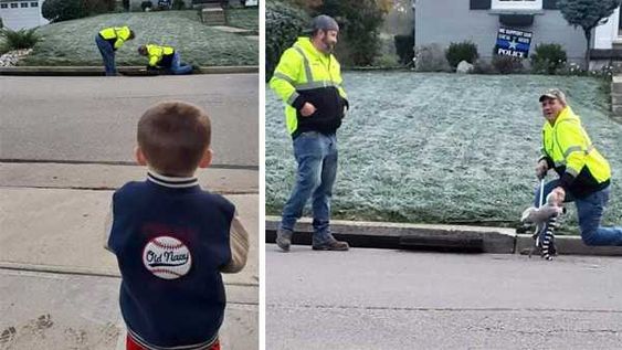 A child in Fort Mitchell Kentucky watches two city employees rescue his toy A child in Fort Mitchell Kentucky watches two city employees rescue his toy