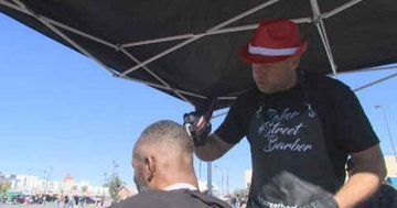 Dana Canfield "The Street Barber" cutting the hair of a client who is homeless Dana Canfield "The Street Barber" cutting the hair of a client who is homeless