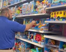 A deputy with the VPSO shopping for toys to be given to children in their community A deputy with the VPSO shopping for toys to be given to children in their community