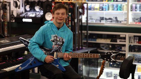 A young boy named Fallon playing a Pantera guitar A young boy named Fallon playing a Pantera guitar
