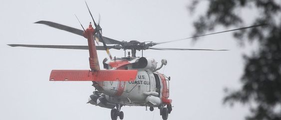 A USCG helicopter to the rescue of six duck hunters stuck in a marsh in Massachusetts