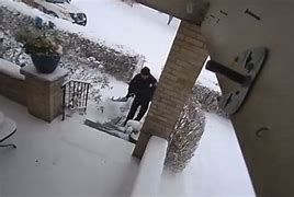 Pittsburgh Police Officer Steinbaugh clearing snow for a resident.