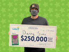 Danny Sims of Ellenboro North Carolina with his winning lottery prize money