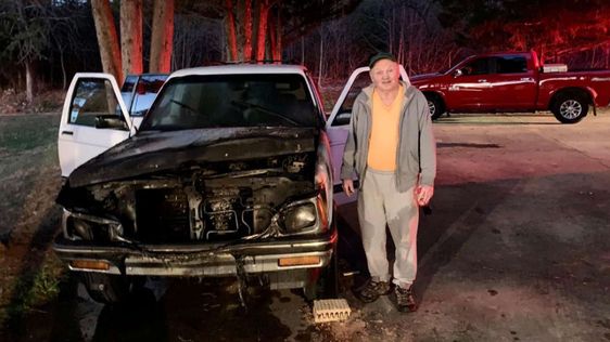 Morganton resident Johnnie Busic and his burned out auto in West Virginia Morganton resident Johnnie Busic and his burned out auto in West Virginia