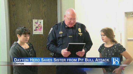 Logan Sefried (R) receives an award from the Dayton Police.