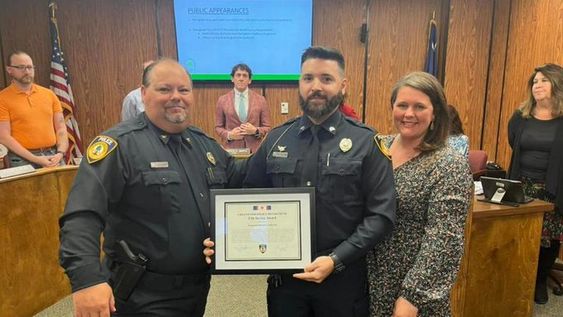 Greenwood Police Chief T J Chaudoin (L) presents an award to officer Cardarelli. Greenwood Police Chief T J Chaudoin (L) presents an award to officer Cardarelli.