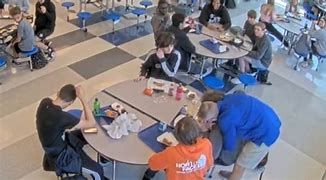Coach Joel Hueser (Blue shirt) saving the life of student Riley Kelly in the lunch room. Coach Joel Hueser (Blue shirt) saving the life of student Riley Kelly in the lunch room.