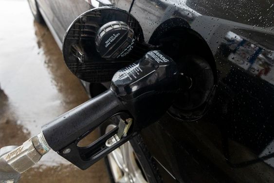 A gasoline tank filling up an auto in Michigan. A gasoline tank filling up an auto in Michigan.