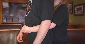 A server at Applebee's restaurant using the Heimlich maneuver on a choking victim. A server at Applebee's restaurant using the Heimlich maneuver on a choking victim.
