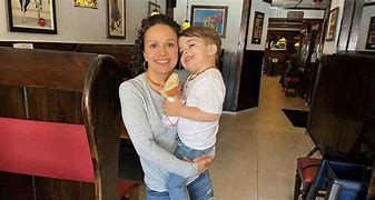 Waitress Jennifer Vernancio and her three year old child. Waitress Jennifer Vernancio and her three year old child.