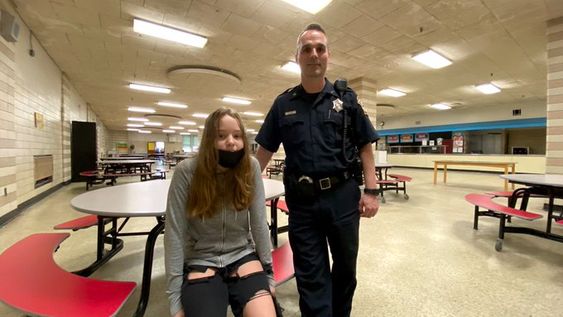 Young girl with Fitchburg police officer Steven Hachey