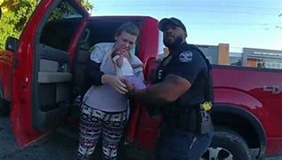 Louisville Police Officer Nick Greene holding Emma after he saved her life.
