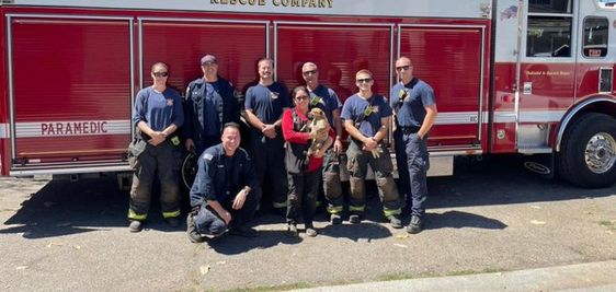 Firefighters in Alameda County with the owner of a small dog that was rescued. Firefighters in Alameda County with the owner of a small dog that was rescued.