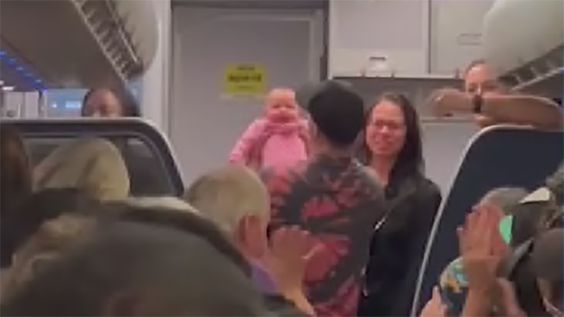Tamara facing the camera is being praised as a savior to a 3 month old girl in an airplane. Tamara facing the camera is being praised as a savior to a 3 month old girl in an airplane.