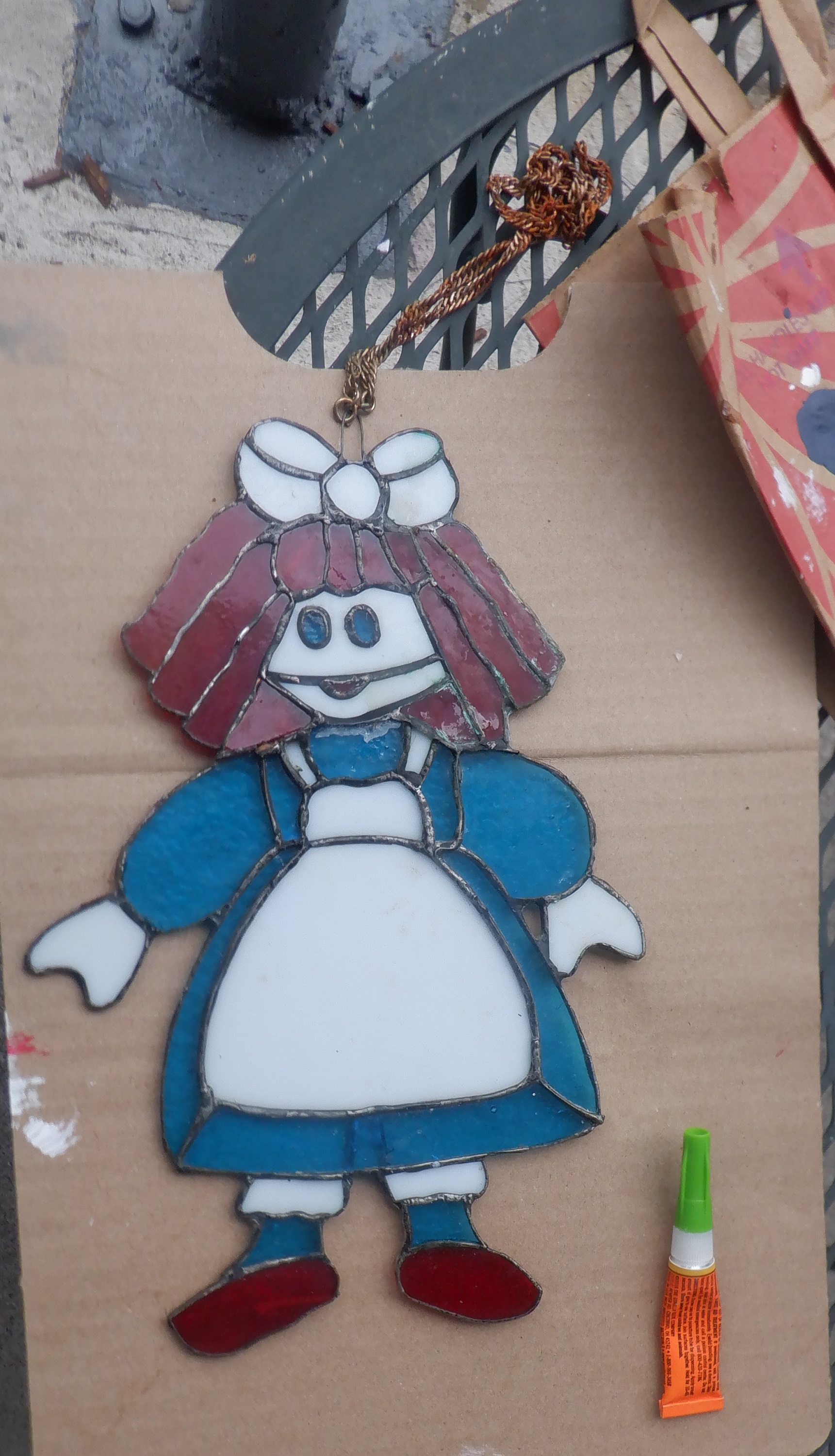 Doll out on the painting/gluing table on the patio Doll out on the painting/gluing table on the patio