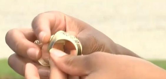 Higel Harris in possession of his missing championship football rings.