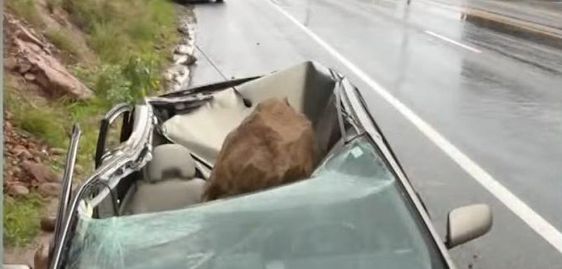 A boulder crushes an auto owned by Maurice Henao. A boulder crushes an auto owned by Maurice Henao.