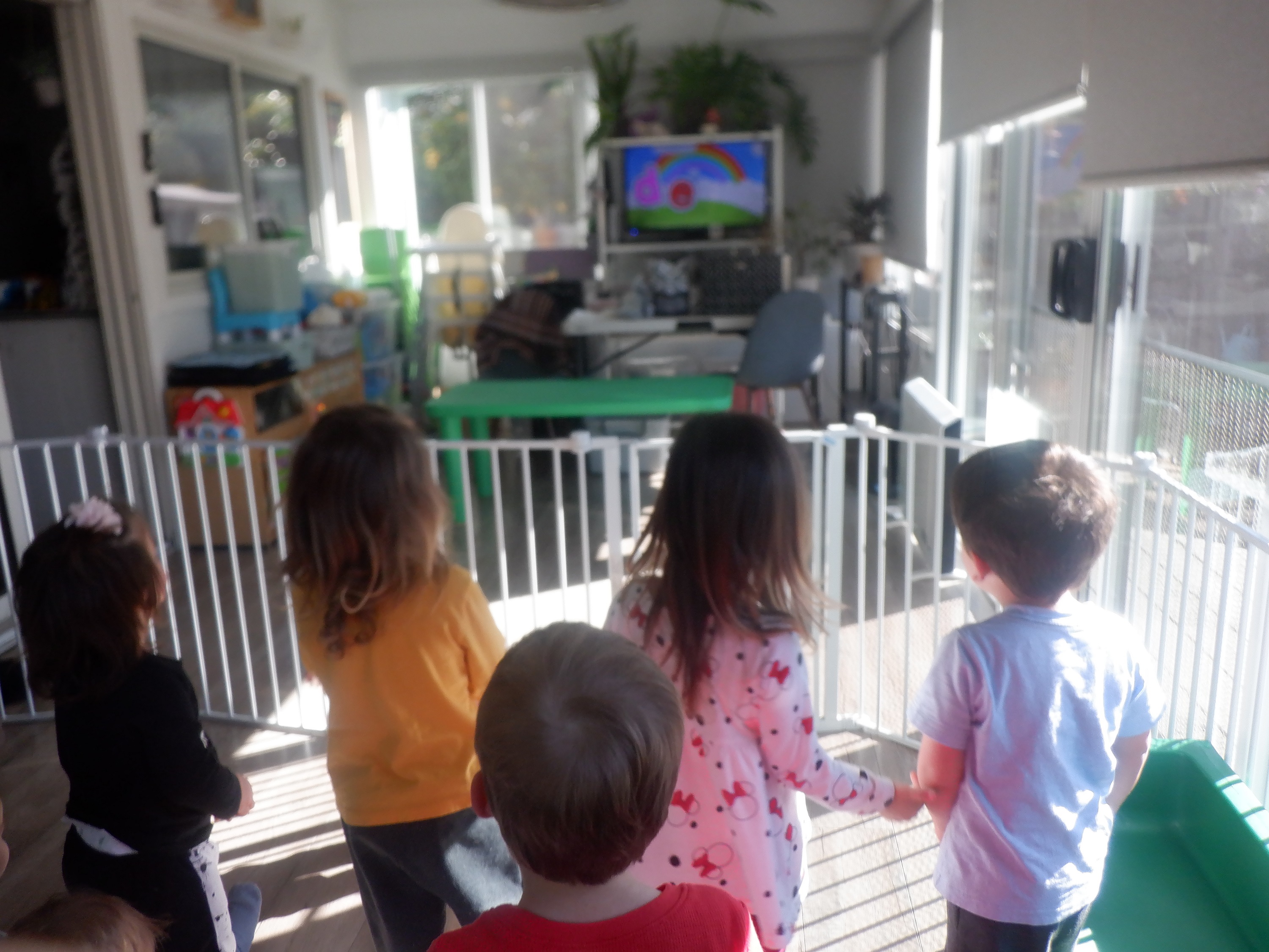 Kids at work watching a video about rainbows