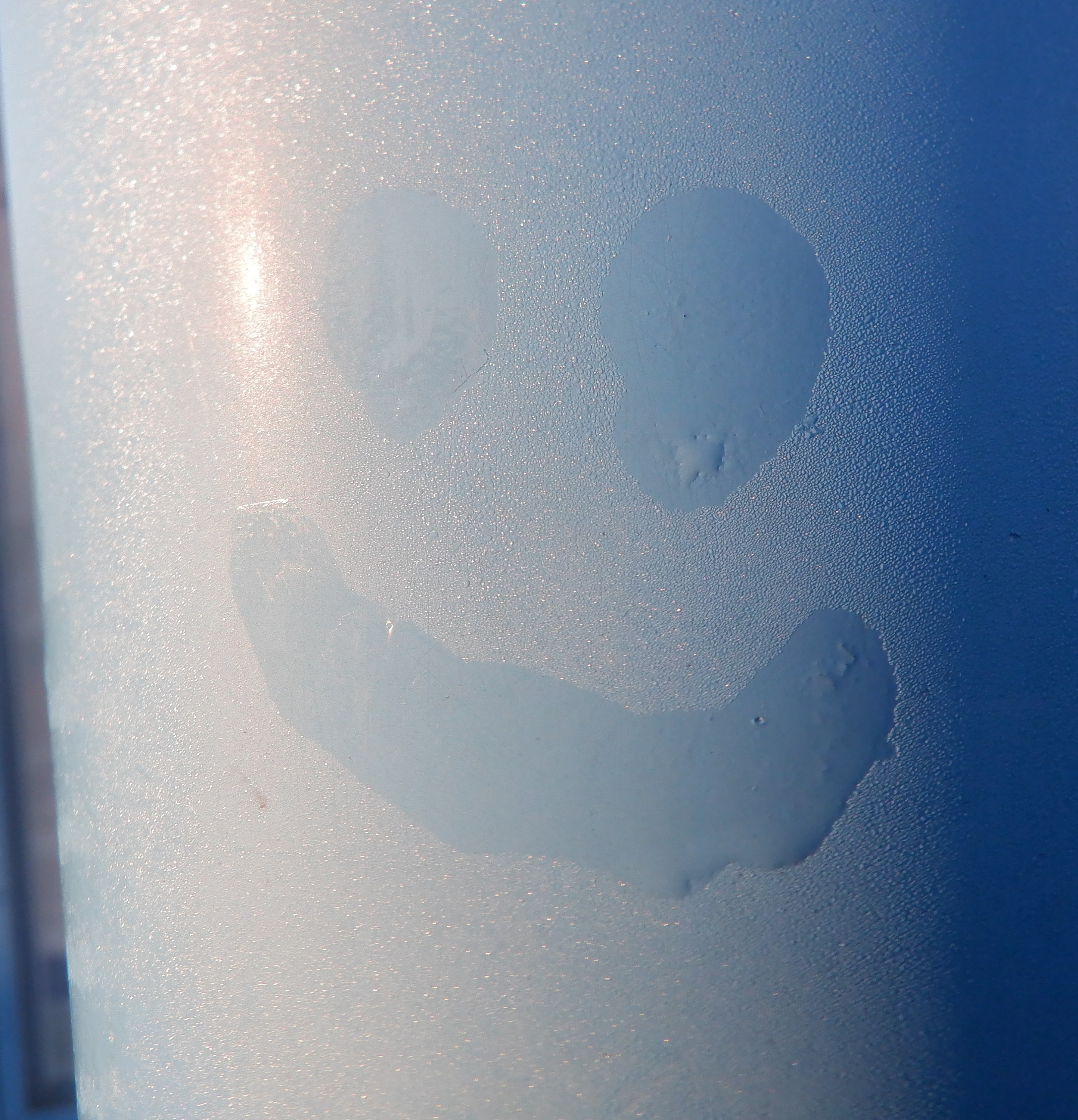 Smiley in the dew on the bus stop post. Smiley in the dew on the bus stop post.