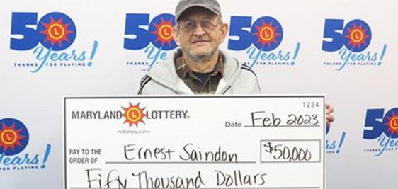 Maryland Lottery winner Ernest Saindon and his winning lottery prize.