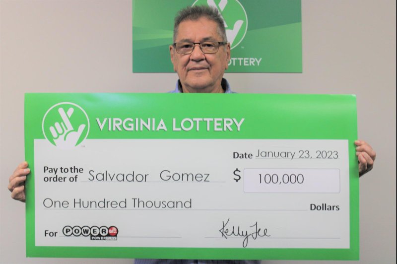 Salvador Gomez showing his $100,000 winning lottery ticket.