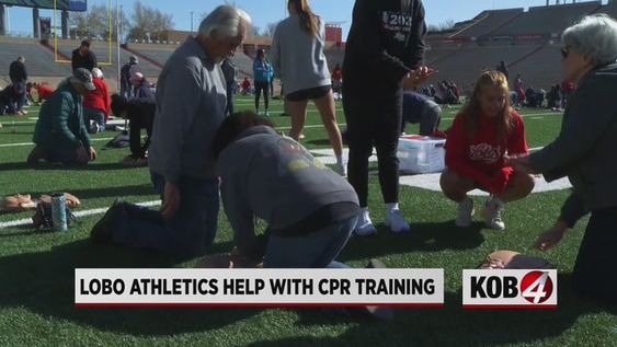 UNM sports stars teaching CPR to the spectators in Aggie Stadium on Saturday