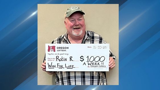 Lucky lottery winner Robin Riedel with his winning prize in Oregon