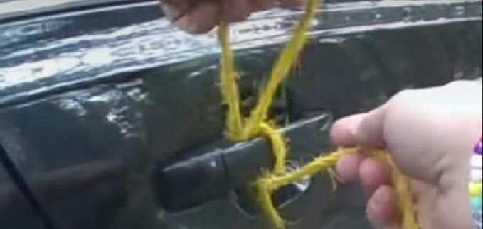 A Washoe County Sheriff&#039;s Office deputy using a rope to the door of an auto