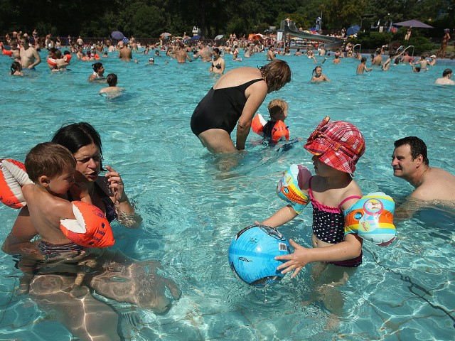 Children and adults in a swimming pool Children and adults in a swimming pool