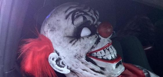 A clown poses as a passenger inside of an auto in Renton Washington